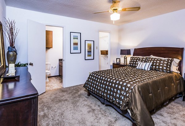Cozy bedroom with modern decor at Fountainhead Apartments, featuring plush bedding and elegant lighting