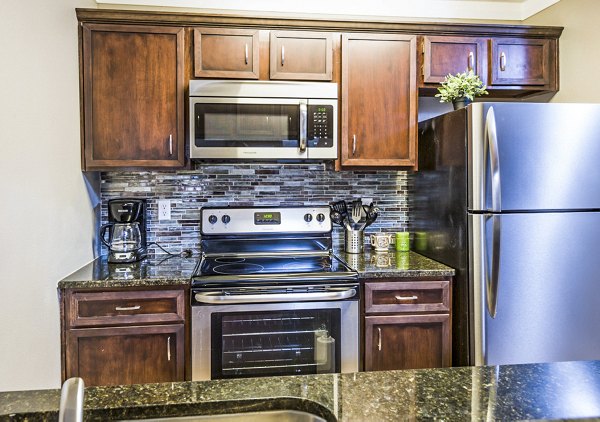 Modern kitchen with stainless steel appliances and quartz countertops at Fountainhead Apartments