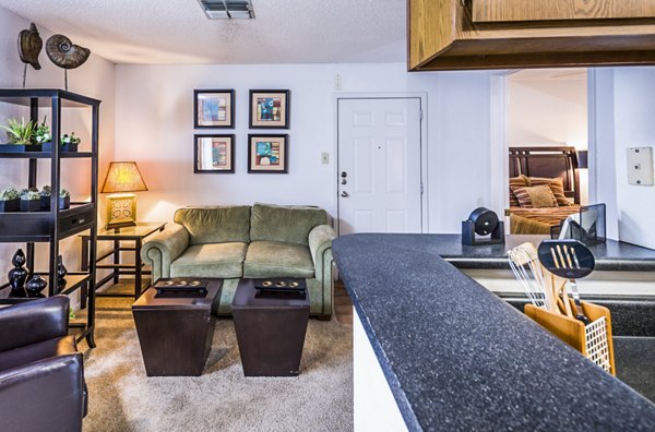 Spacious living room with modern decor and large windows at Fountainhead Apartments