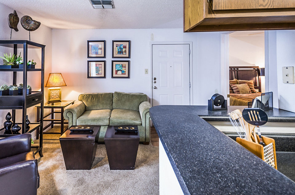 Spacious living room with modern decor and large windows at Fountainhead Apartments
