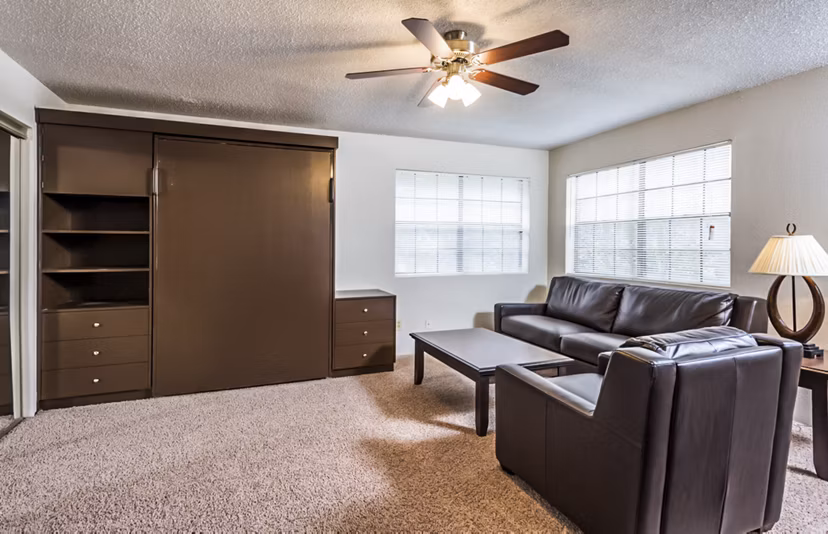 Contemporary living room with large windows at Fountainhead Apartments
