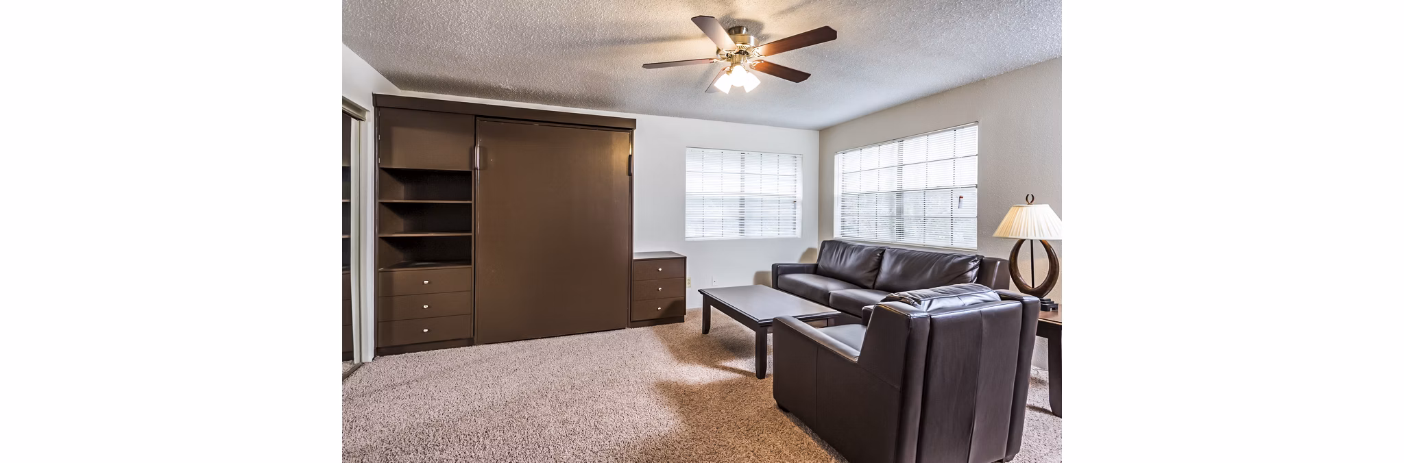 Contemporary living room with large windows at Fountainhead Apartments