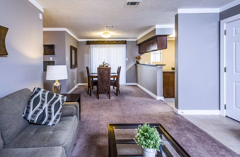 Modern living room with stylish decor at Fountainhead Apartments featuring a large sofa and wall art