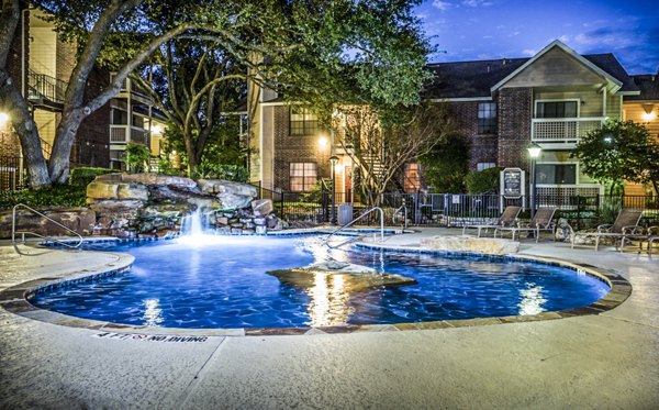 Relaxing pool with waterfall feature at Fountainhead Apartments, luxury living in serene surroundings