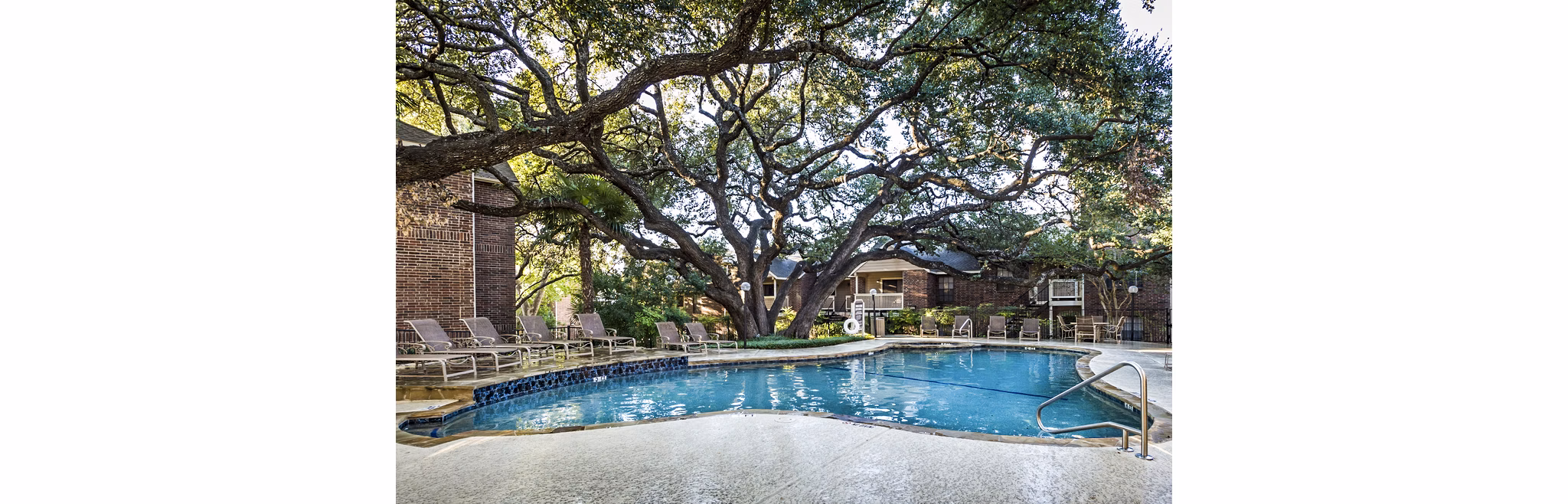 Luxurious pool area with comfortable lounge chairs at Fountainhead Apartments