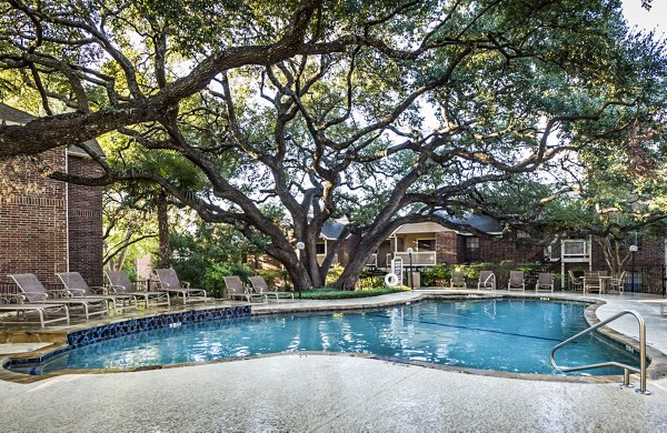 Luxurious pool area with comfortable lounge chairs at Fountainhead Apartments