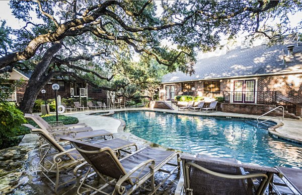 Luxurious poolside at Fountainhead Apartments with lounge chairs and scenic views