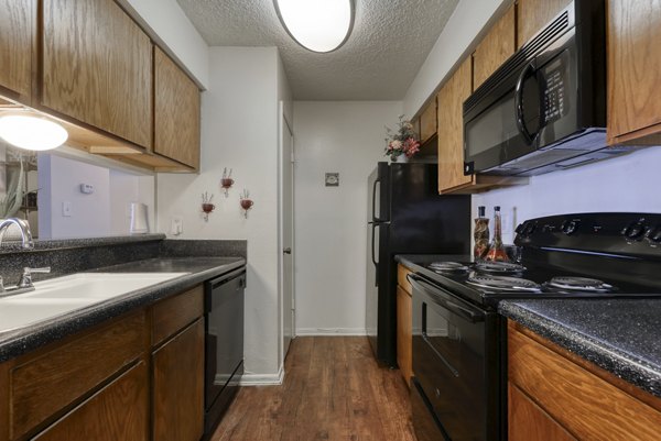 Kitchens at Landera Apartments: Modern design with stainless steel appliances and granite countertops