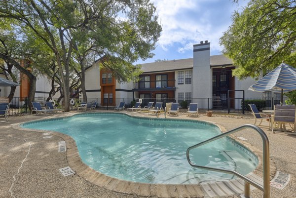 Resort-style pool with lounging area at Landera Apartments
