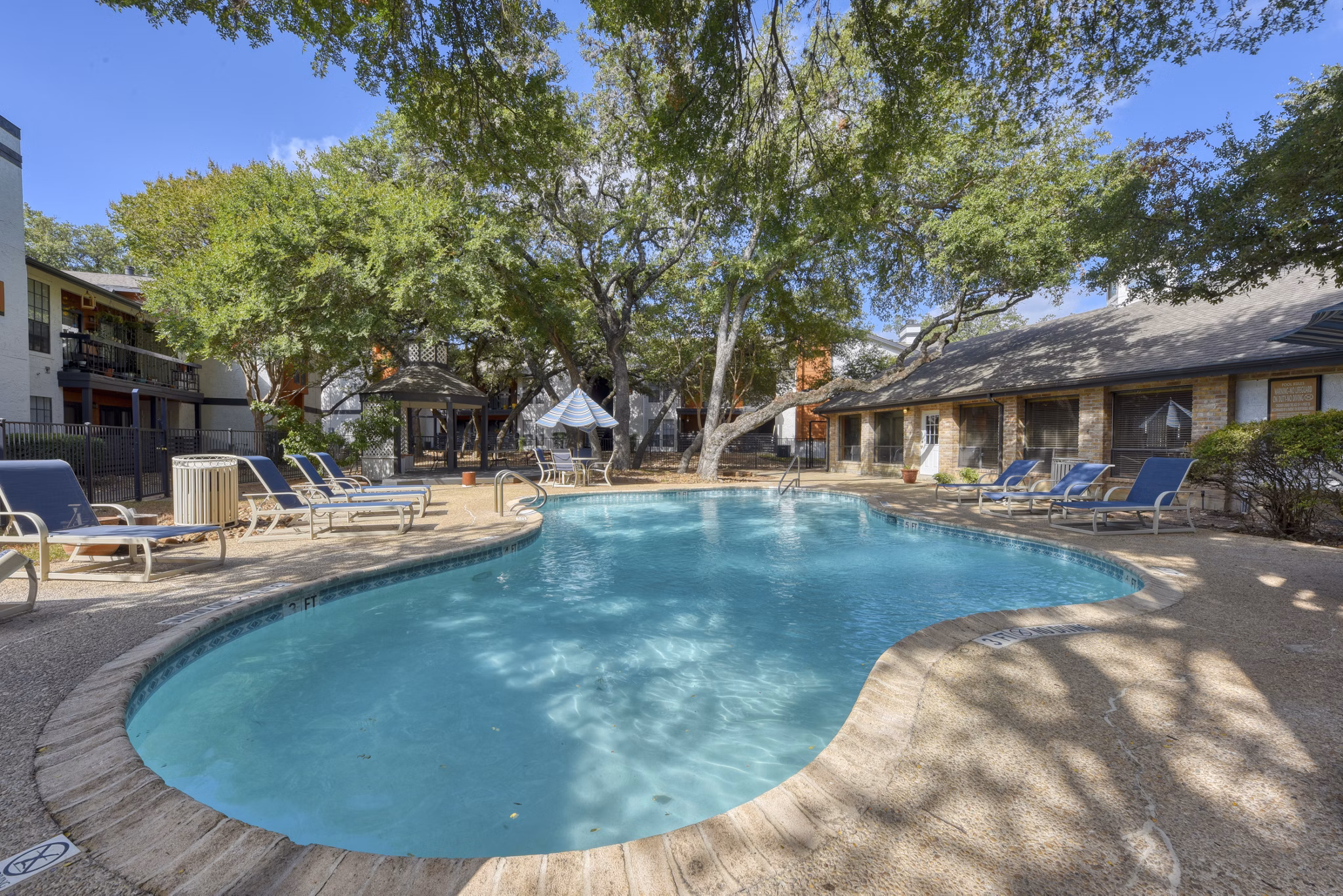 Luxurious outdoor pool with lounge chairs at Landera Apartments, perfect for relaxation and socializing