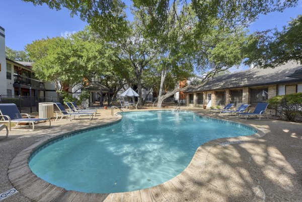 Luxurious outdoor pool with lounge chairs at Landera Apartments, perfect for relaxation and socializing