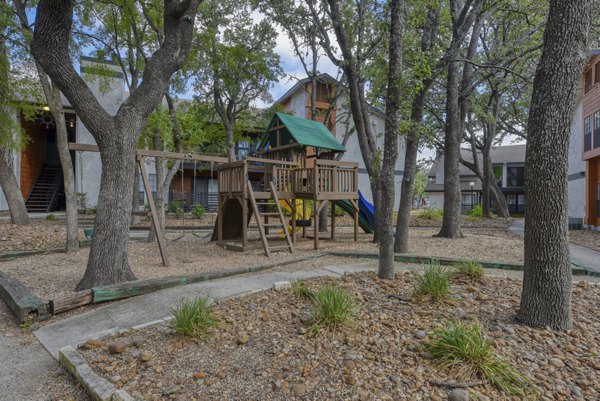 Colorful playground featuring slides and climbing structures at Landera Apartments, perfect for family-friendly outdoor fun