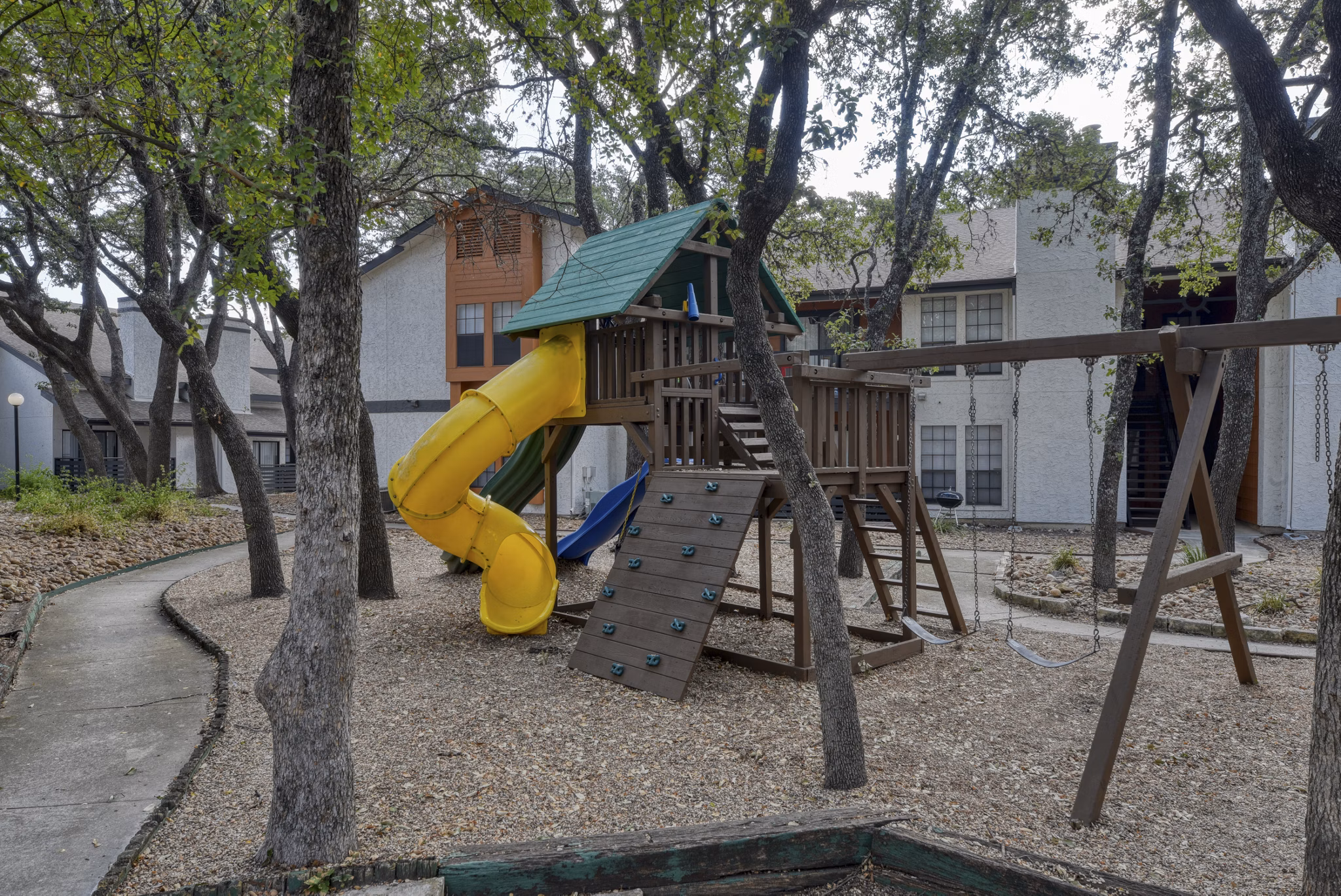 Community playground with slides and swings at Landera Apartments, perfect for family fun and children's recreation