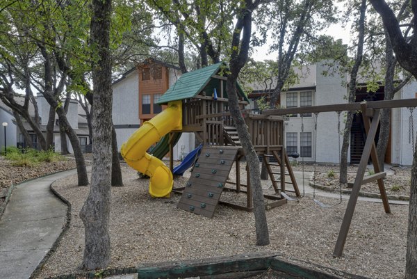 Community playground with slides and swings at Landera Apartments, perfect for family fun and children's recreation