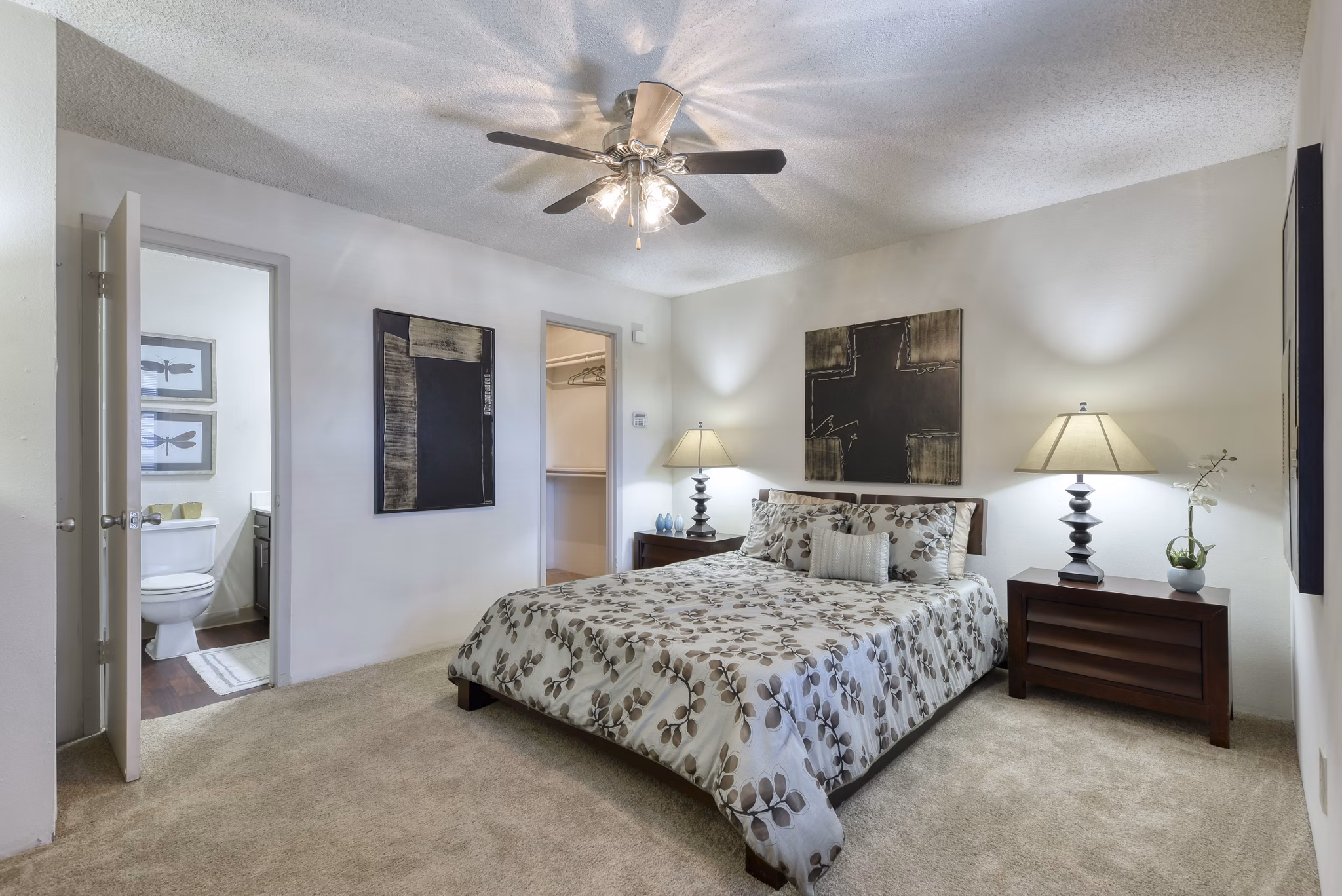 Bedroom with plush bedding and modern decor at Broadstone Medical Apartments