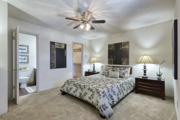 Bedroom with plush bedding and modern decor at Broadstone Medical Apartments