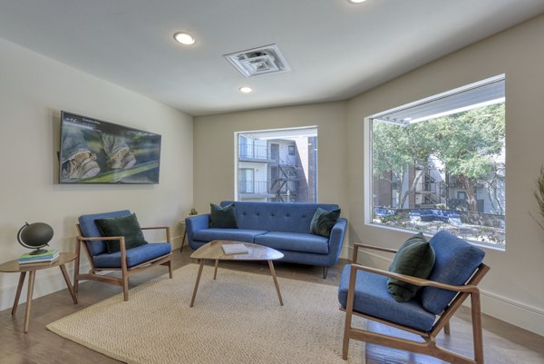 Sunny outdoor seating area of the clubhouse at Broadstone Medical Apartments featuring lush landscaping and modern design
