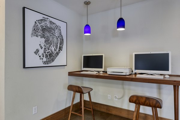 Business center with sleek workstations at Broadstone Medical Apartments, offering modern amenities and collaborative environments