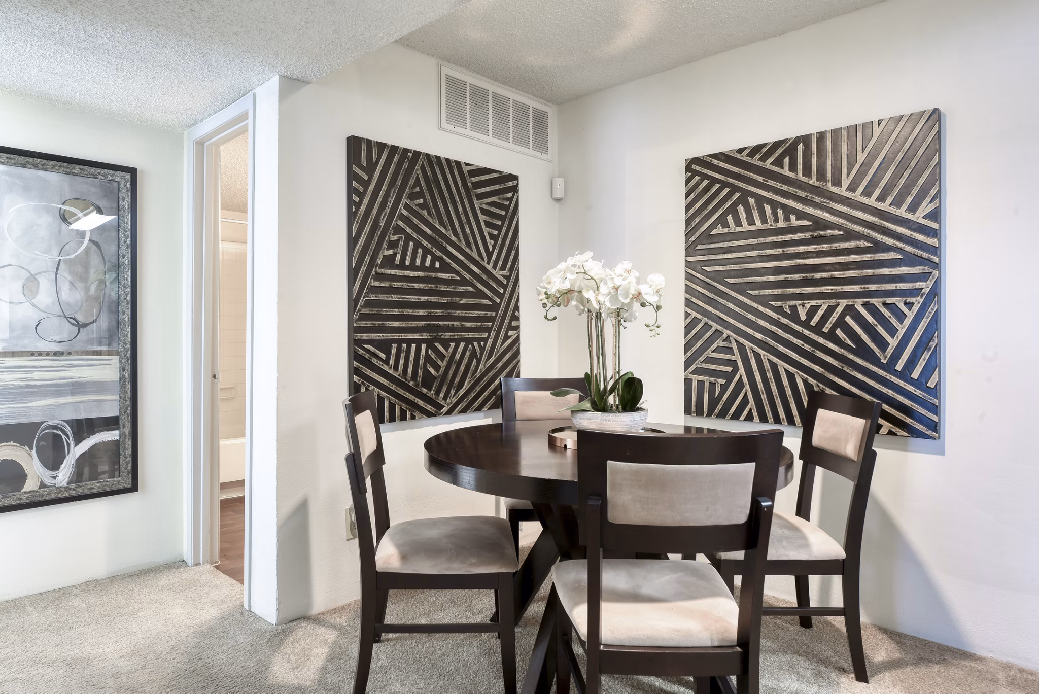 Dining area with elegant decor at Broadstone Medical Apartments, showcasing modern design and sleek furniture setup