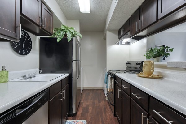 Modern kitchen with stainless steel appliances at Broadstone Medical Apartments