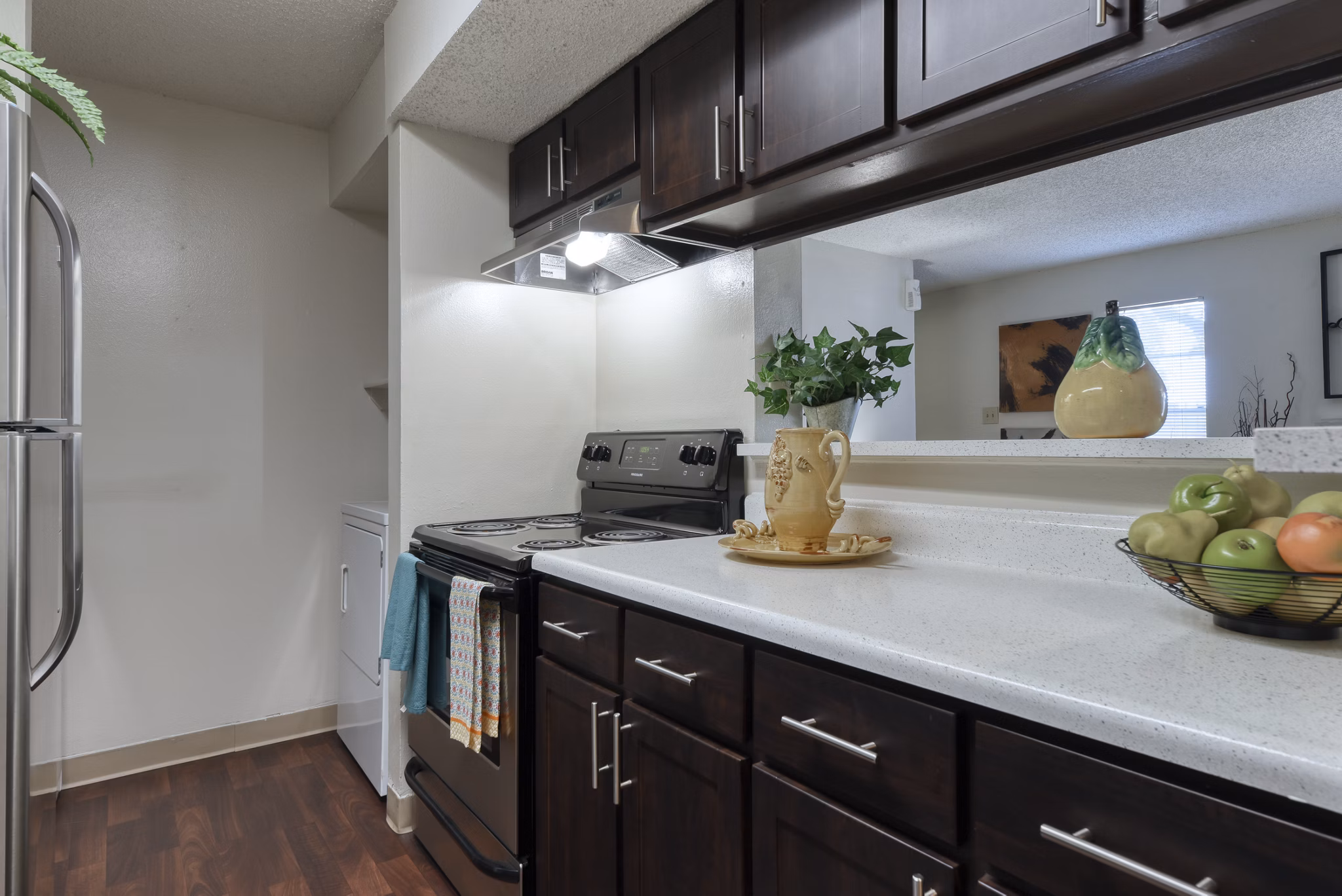 Kitchen featuring modern appliances and granite countertops in Broadstone Medical Apartments
