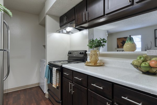 Kitchen featuring modern appliances and granite countertops in Broadstone Medical Apartments