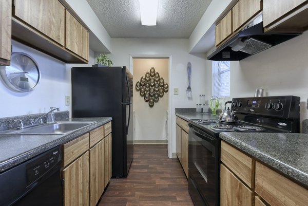 Modern kitchen featuring sleek countertops and stainless steel appliances in Broadstone Medical Apartments