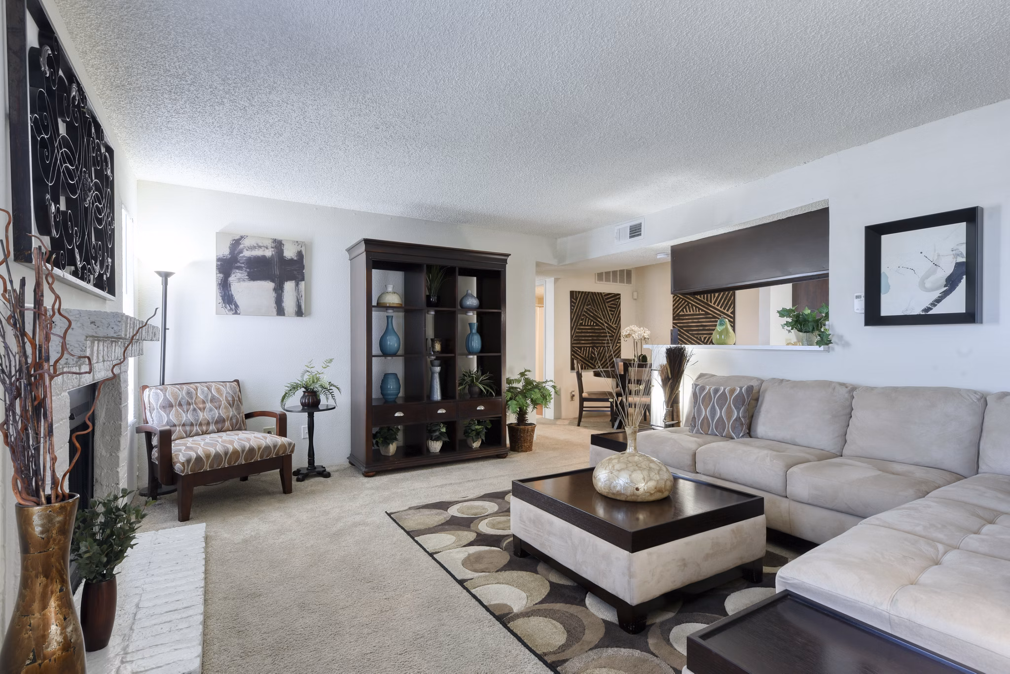 Living room featuring modern furniture and bright lighting at Broadstone Medical Apartments
