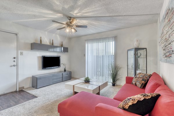 Modern living room with plush seating and large windows at Broadstone Medical Apartments