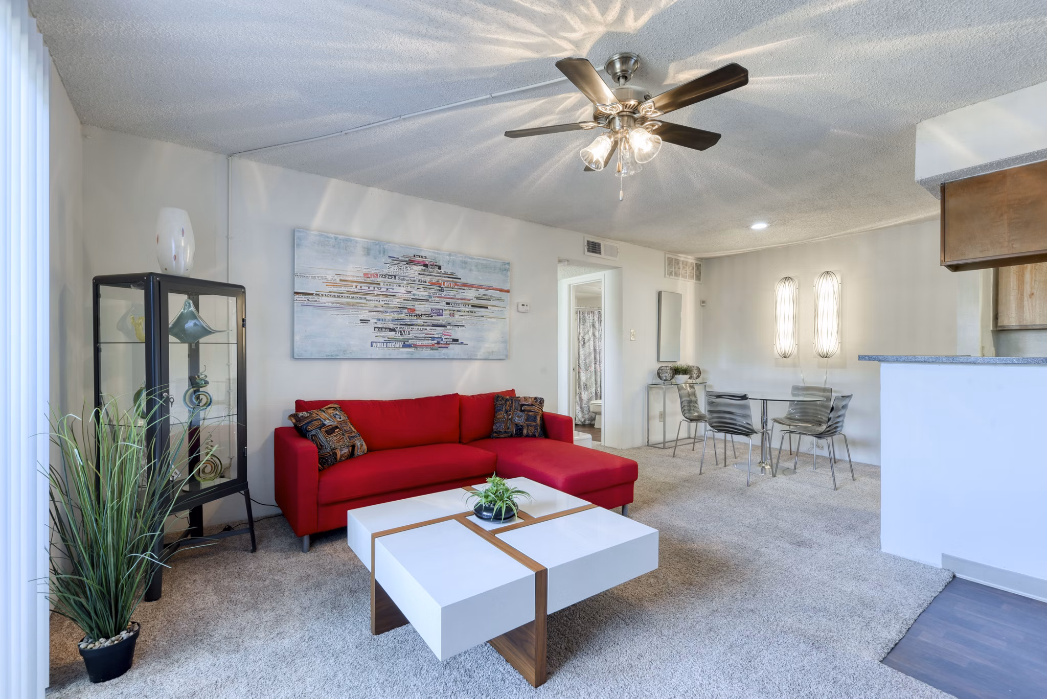 Living room with modern decor and large windows at Broadstone Medical Apartments