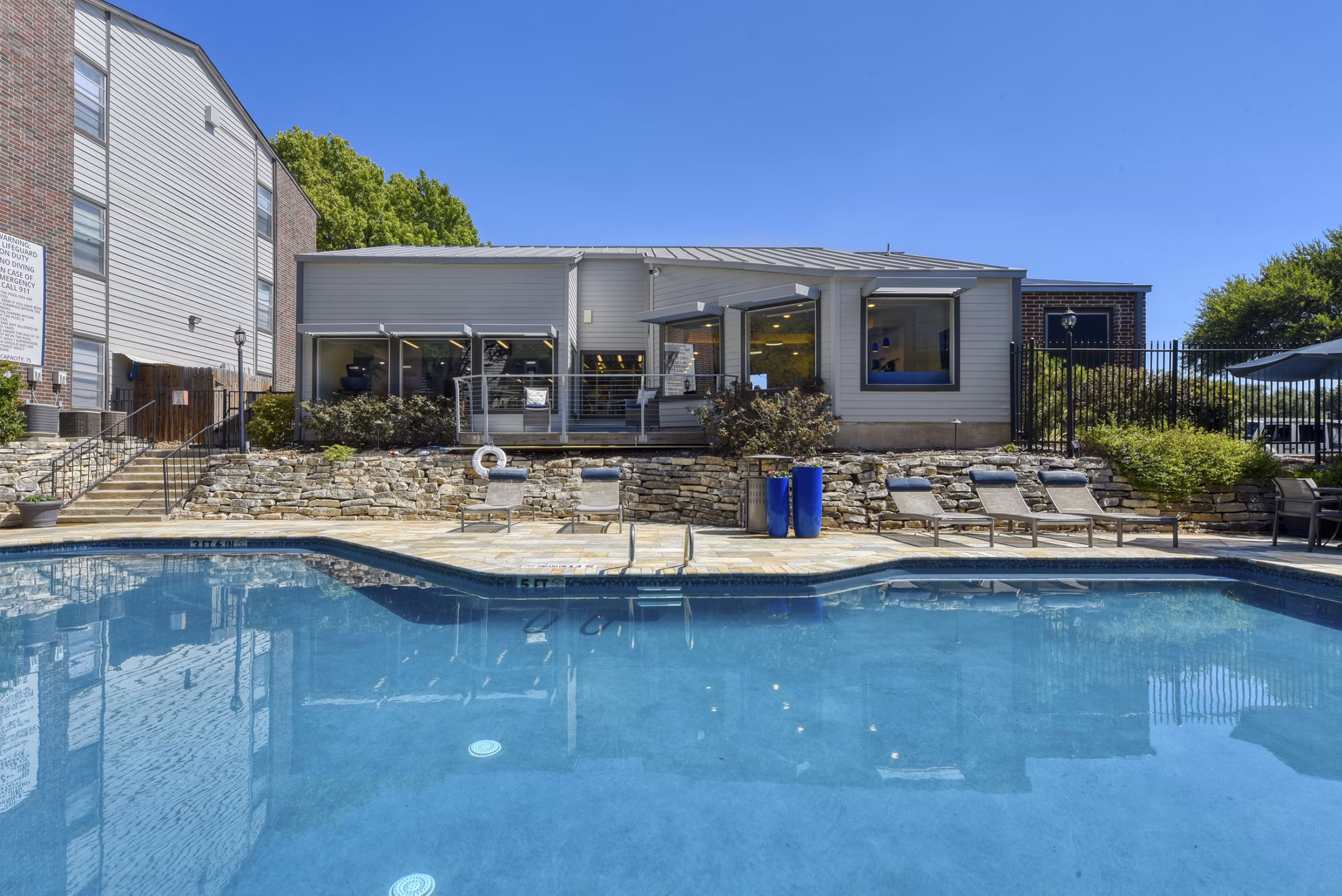 Modern outdoor pool at Broadstone Medical Apartments offering luxury relaxation spaces in a serene setting