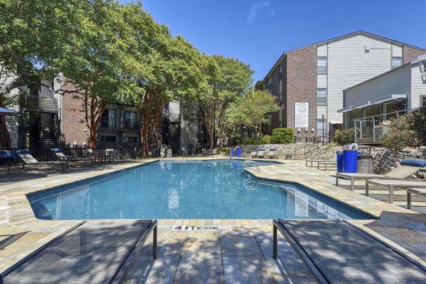 Resort-style pool with sun loungers at Broadstone Medical Apartments, ideal for relaxation and leisure