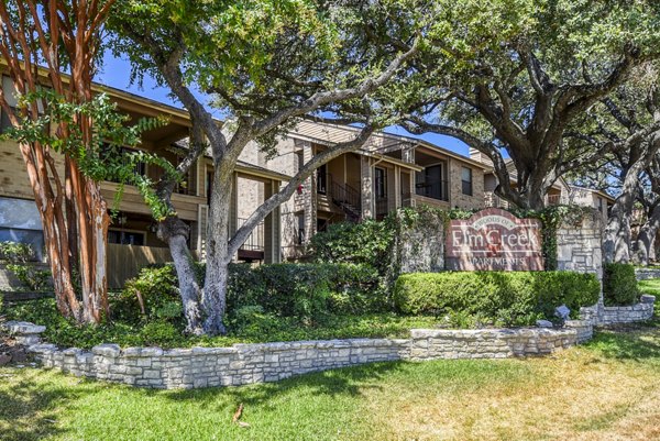Woods of Elm Creek: Classic brick with distinctive signage in a tranquil San Antonio location Luxury living defined