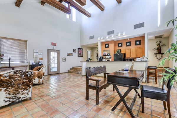 Clubhouse lobby featuring modern design and comfortable seating at Woods of Elm Creek Apartments