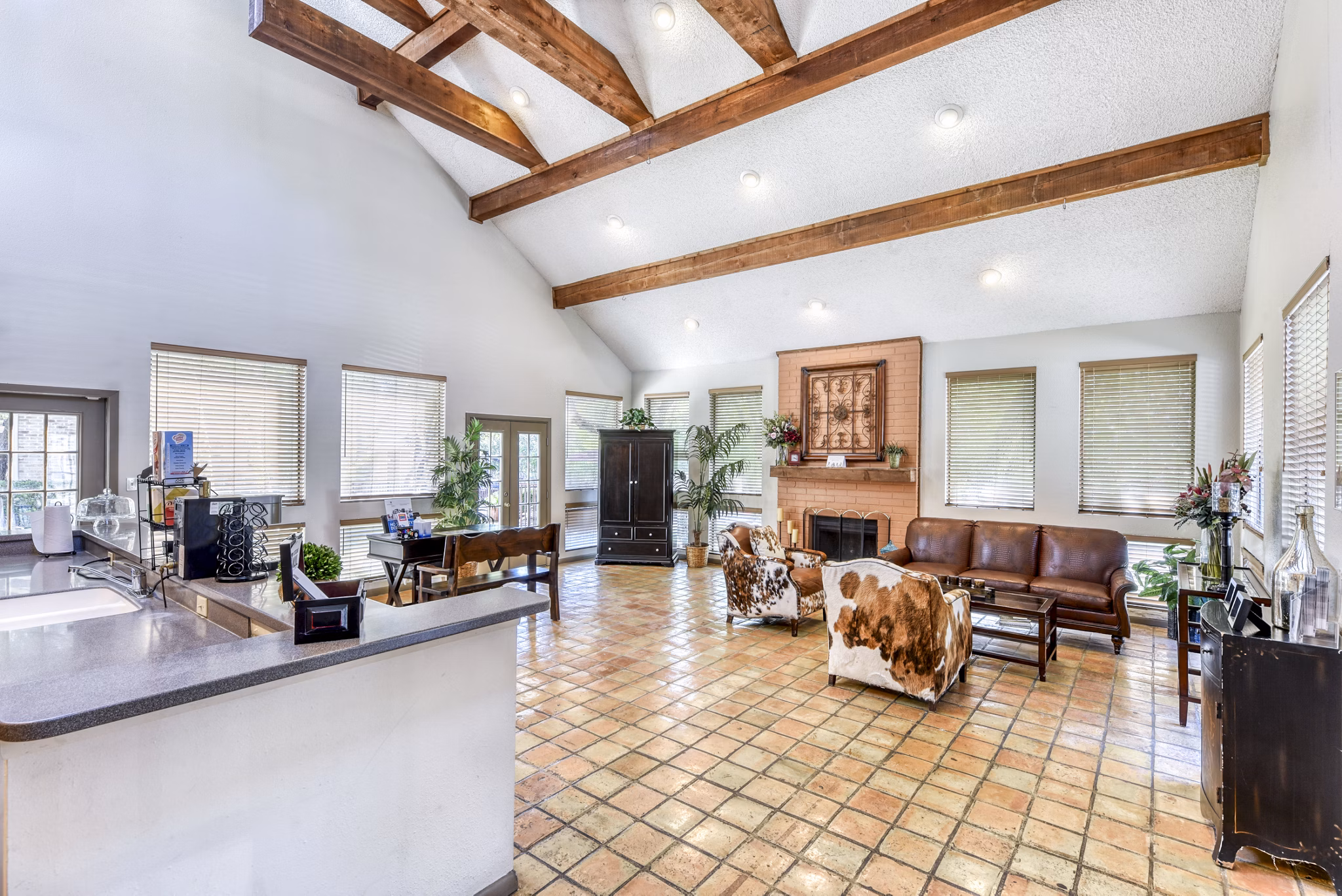 Welcoming clubhouse lobby with modern seating at Woods of Elm Creek Apartments, featuring stylish decor and ample space for relaxation and gatherings