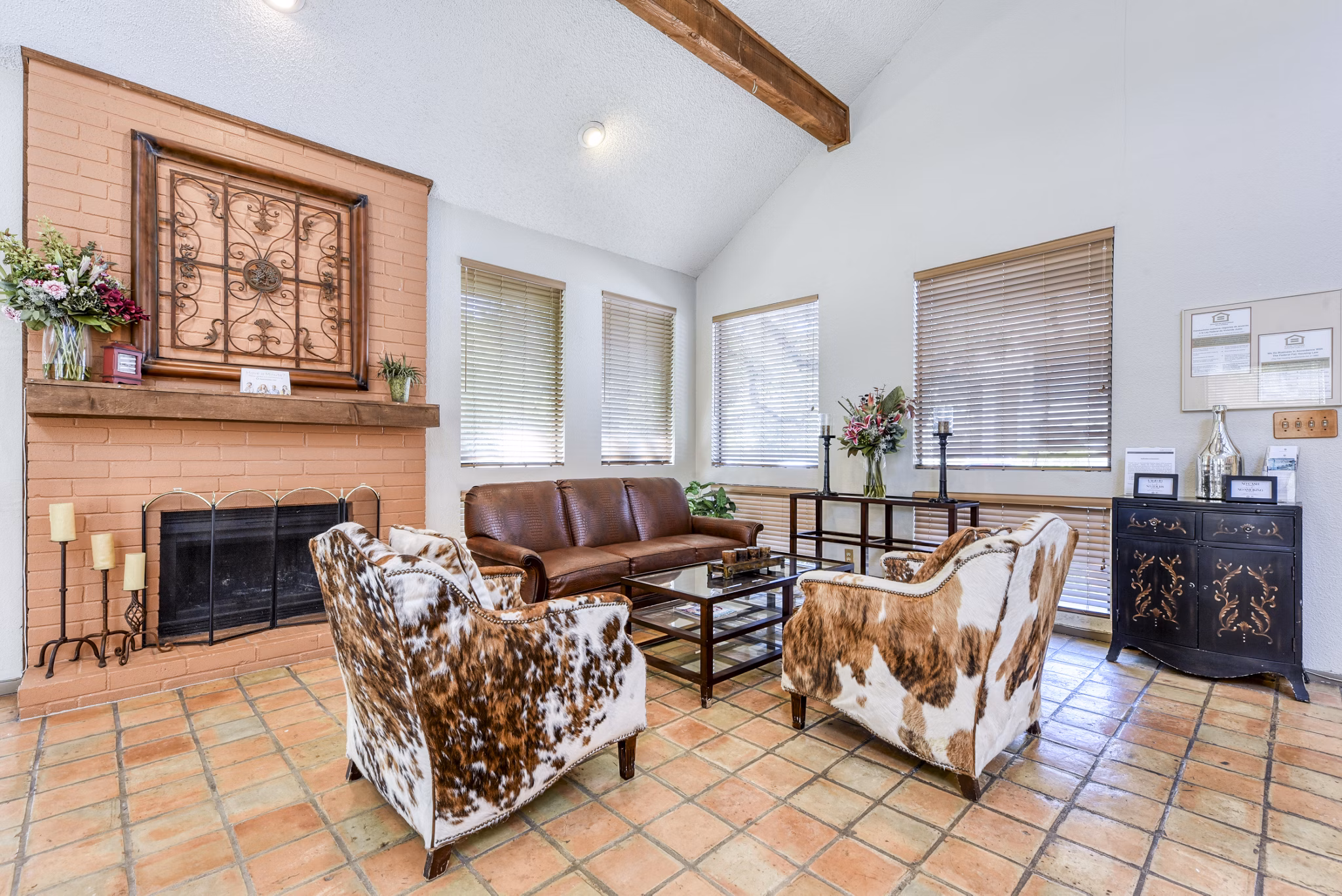 Clubhouse lobby with modern seating and lighting at Woods of Elm Creek Apartments, creating a welcoming community space