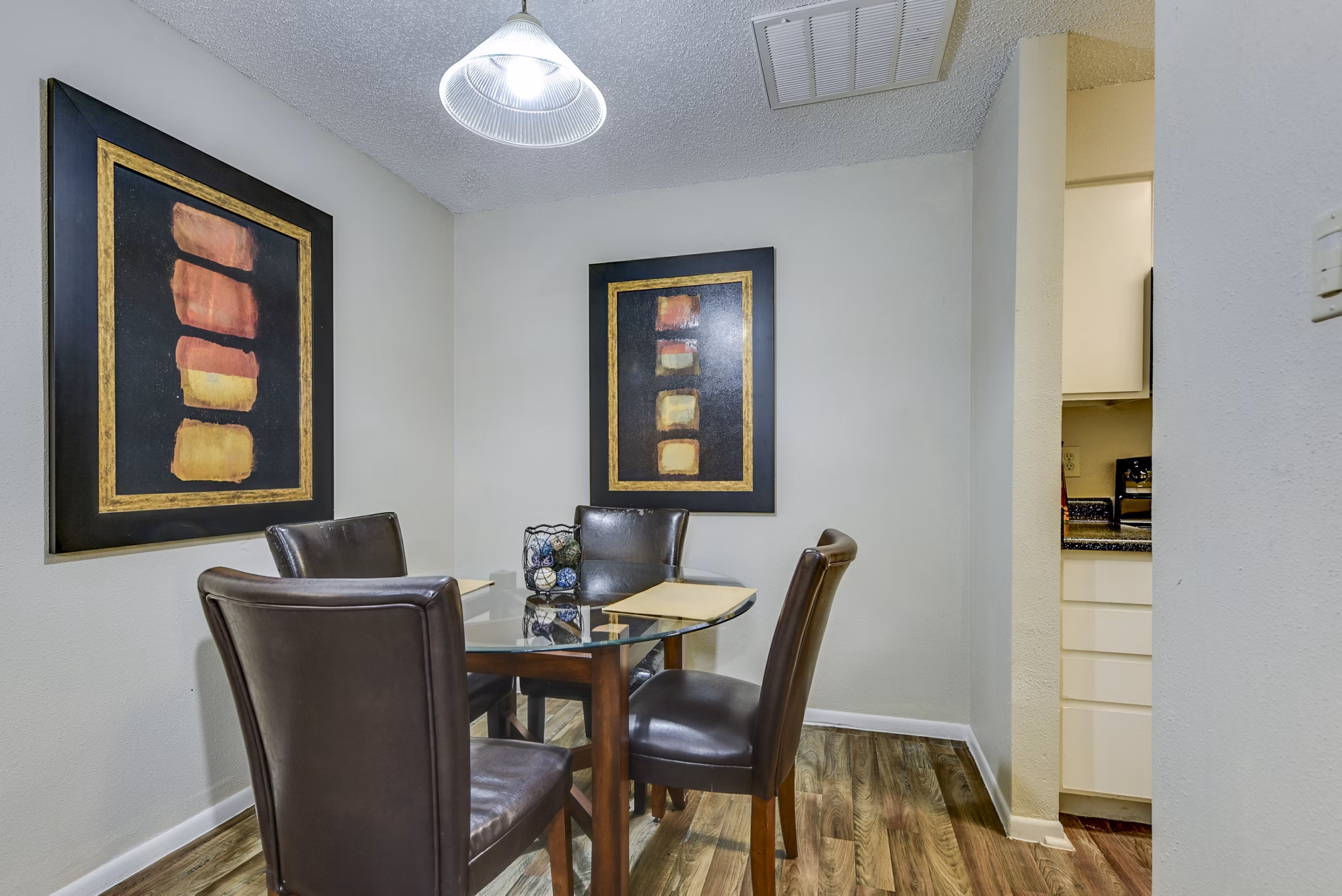 Dining area with modern furnishings and large windows at Woods of Elm Creek Apartments
