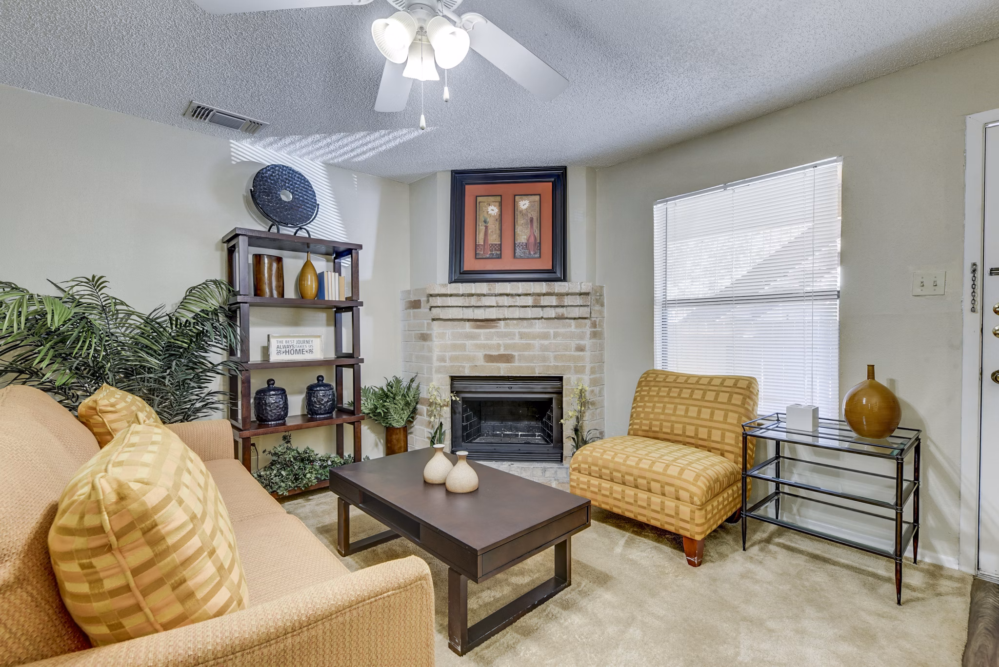 Living room with cozy seating and natural light at Woods of Elm Creek Apartments