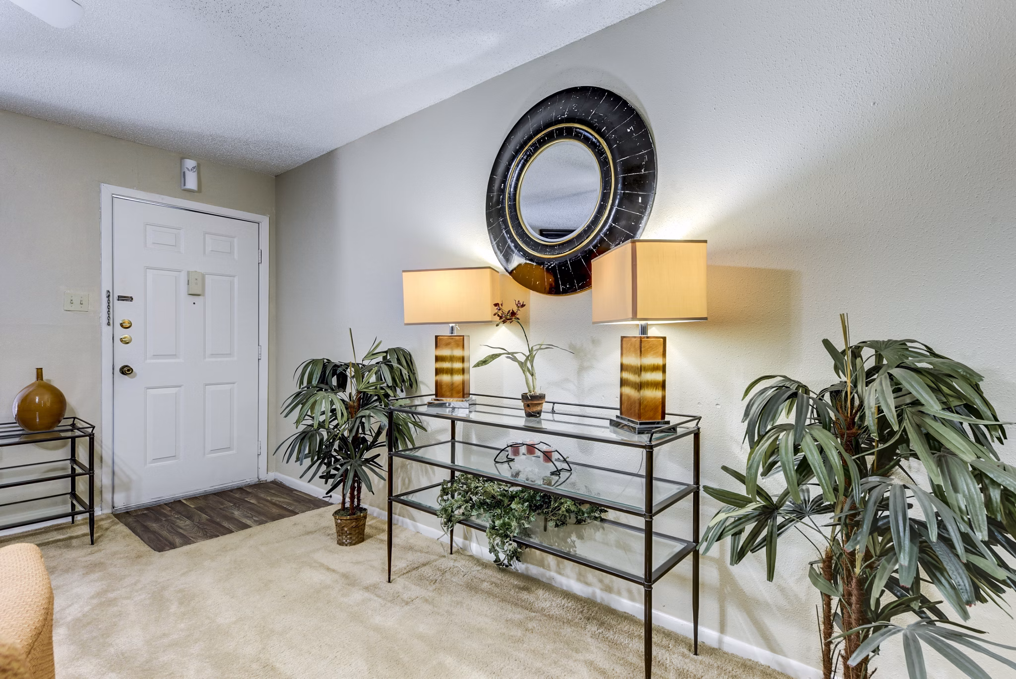 Living room with cozy seating and a fireplace at Woods of Elm Creek Apartments