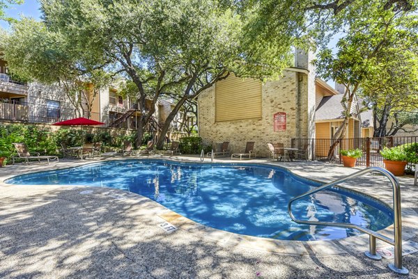 Rooftop pool with scenic views at Woods of Elm Creek Apartments