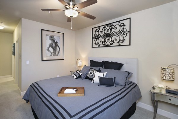 Spacious bedroom with modern decor at Fiori Estates Apartments, featuring ample natural light and elegant design