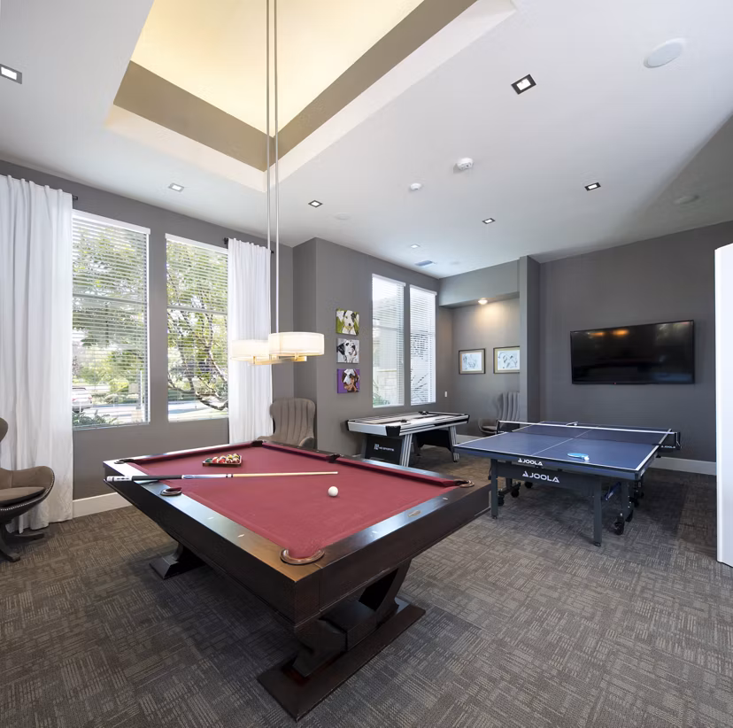 Vibrant game room with pool table and seating at Fiori Estates Apartments, ideal for socializing and relaxation