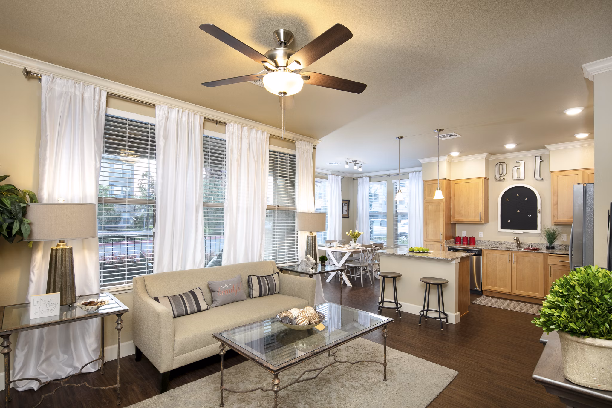 Spacious living room with modern decor and natural light in Fiori Estates Apartments