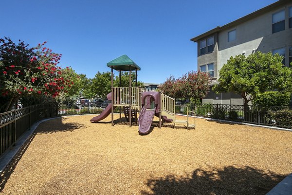 Colorful playground with modern equipment at Fiori Estates Apartments