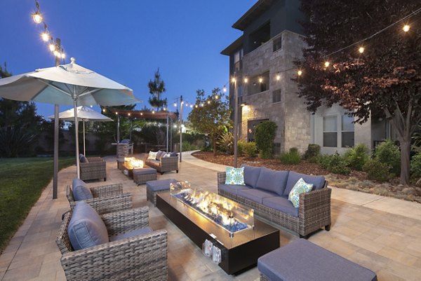 Cozy outdoor fire pit area at Fiori Estates Apartments, ideal for relaxation and social gatherings