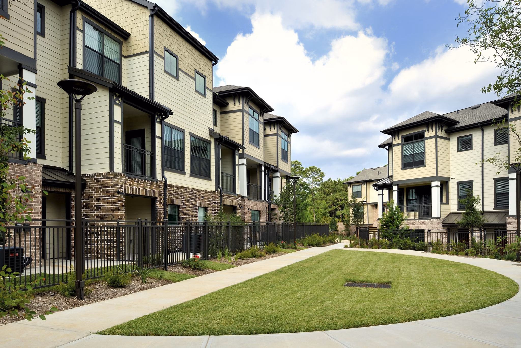 Serene courtyard with lush greenery at The Townhomes at Woodmill Creek, offering a tranquil retreat in a luxury apartment community