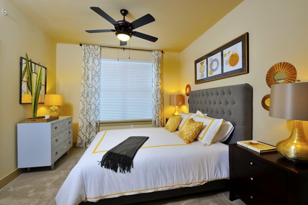 The Townhomes at Woodmill Creek: Cozy bedroom with neutral decor and ample natural light