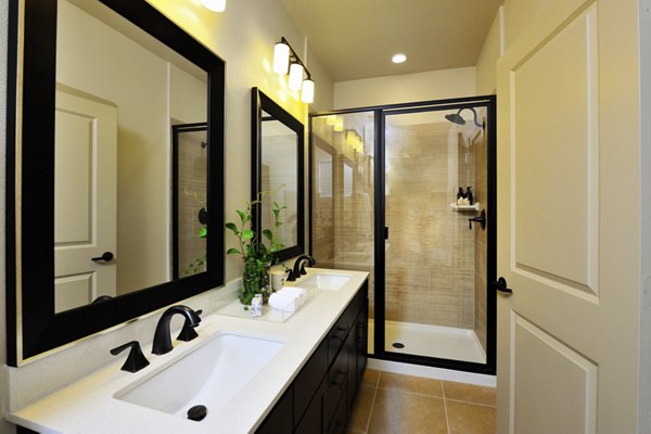 Bathroom designed with modern fixtures and natural light at The Townhomes at Woodmill Creek