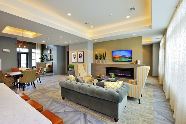 Clubhouse featuring elegant design and cozy seating at The Townhomes at Woodmill Creek luxury apartments