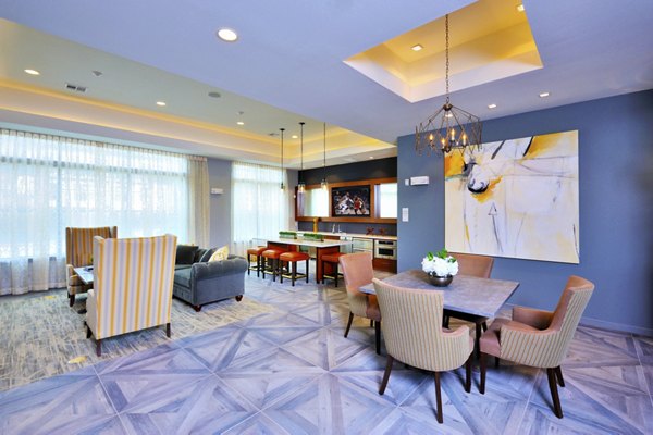 Clubhouse featuring modern furniture and open seating at The Townhomes at Woodmill Creek luxury apartments